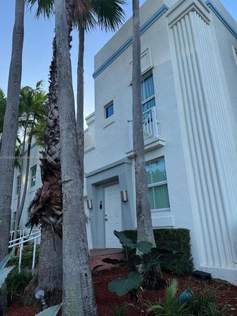 Front view of a modern two-story building with columns and a white facade.