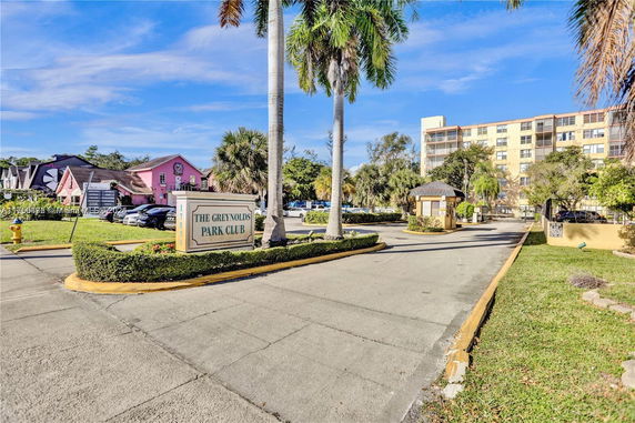 Front view of a multi-story residential building with a gated entry.