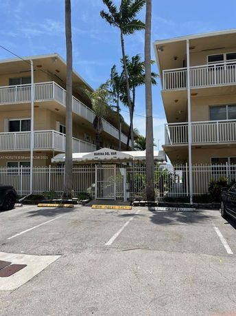 Front view of a multi-story building with balconies.