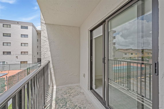 Balcony view overlooking residential area with neighboring buildings.