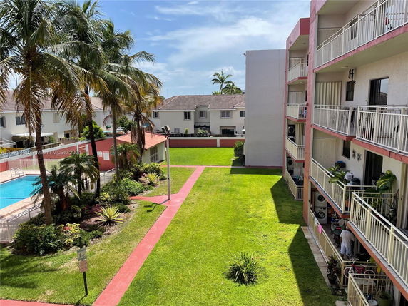 Outdoor area with apartment buildings and a swimming pool.