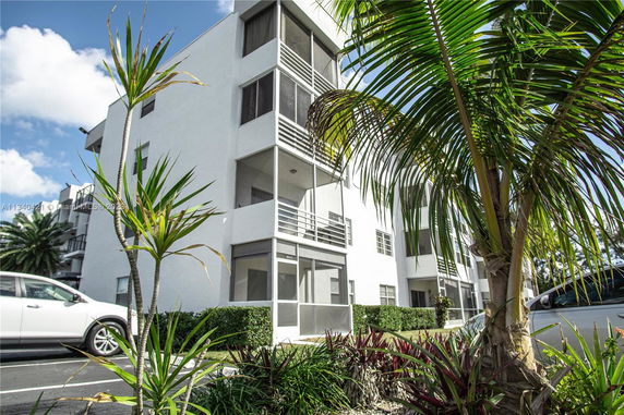 Front view of a multi-story apartment building with balconies.