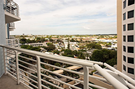 Panoramic view from a high-rise building balcony overlooking suburban area.