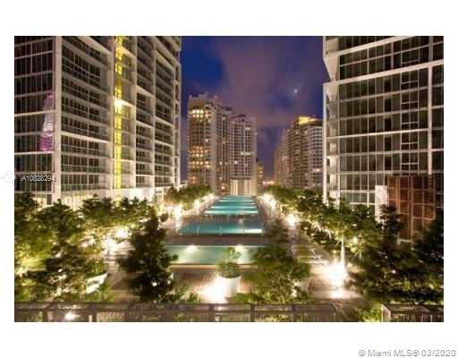 Night view of an urban area with high-rise buildings and illuminated landscape.