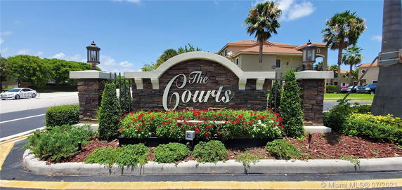 Front view of a residential entrance sign with the text 'The Courts.'