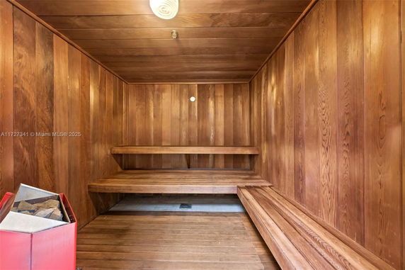 Interior view of a wooden sauna room with benches.