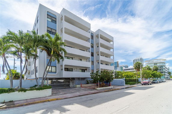 Front view of a multi-story residential building with balconies.