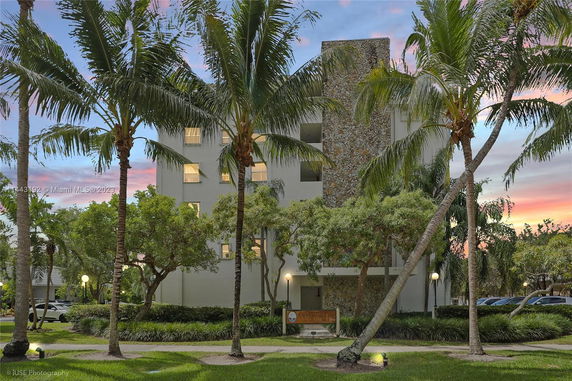 Front view of a multi-story building with a stone accent panel.