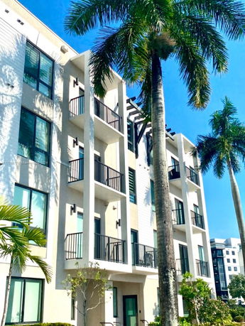 Front view of a multi-story residential building with balconies.