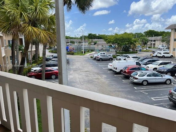 View of outdoor parking area with multiple cars.