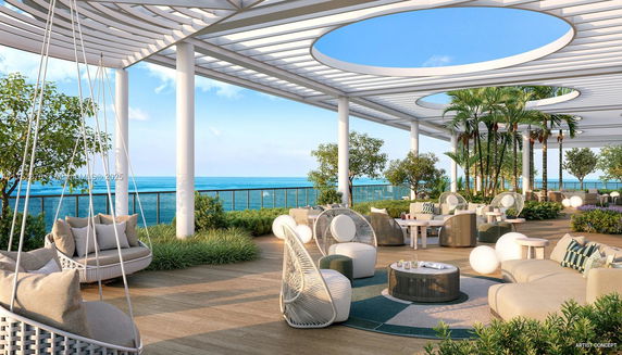 Rooftop with modern outdoor seating, plants, and ocean view.