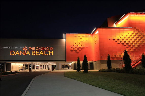 Front view of a casino building with illuminated signage at night.