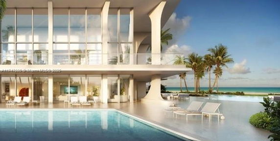 Modern building with a swimming pool overlooking the ocean.
