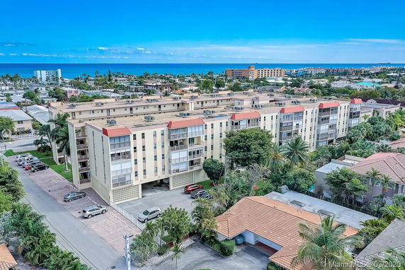 Aerial view of a multi-story residential building near the coastline.