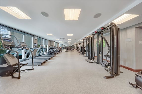 Interior view of a gym with exercise equipment lined up.