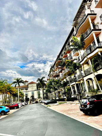 Front view of a multi-story residential building with balconies.