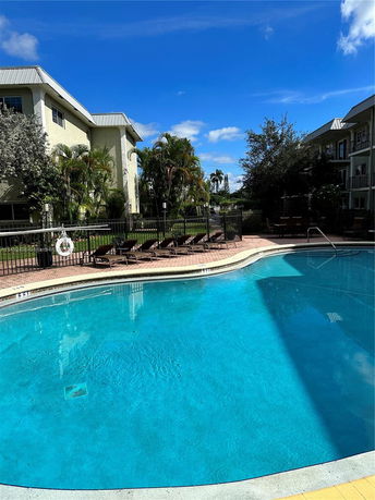 Image of a swimming pool area surrounded by residential buildings.