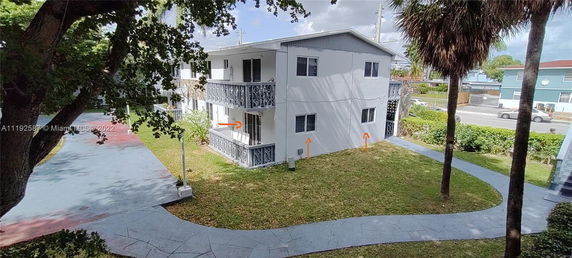 Side view of a two-story apartment building with balconies.
