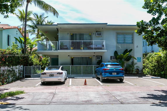 Front view of a two-story building with balconies.