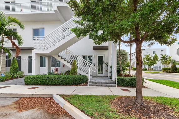Front view of a modern multi-story building with exterior stairs.
