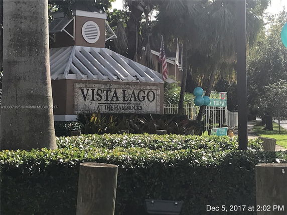 Front view of a building with a sign reading 'Vista Lago at the Hammocks.'