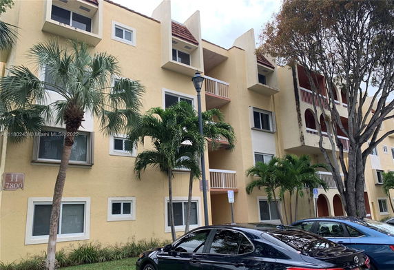 Front view of a multi-story residential building with balconies.