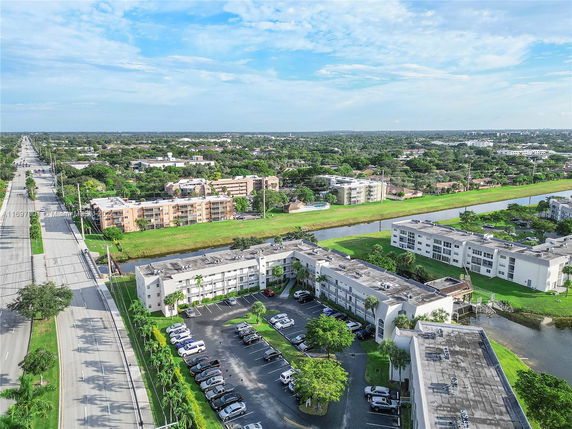 Aerial view of residential buildings with surrounding roads and greenery.