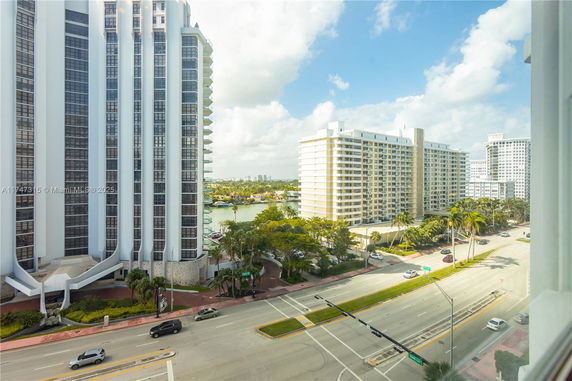 View of tall residential buildings with street and greenery visible.
