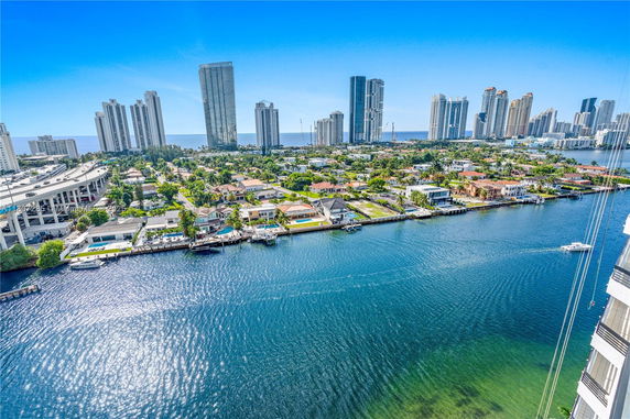 Panoramic view of a cityscape with skyscrapers and waterway.