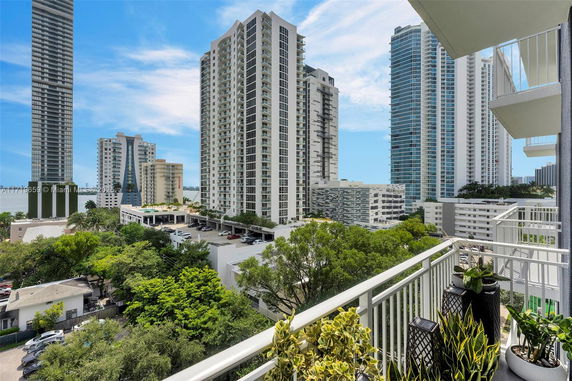 Panoramic view of high-rise buildings seen from a balcony.