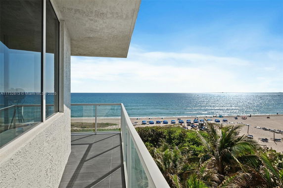 Balcony view overlooking the beach and ocean.