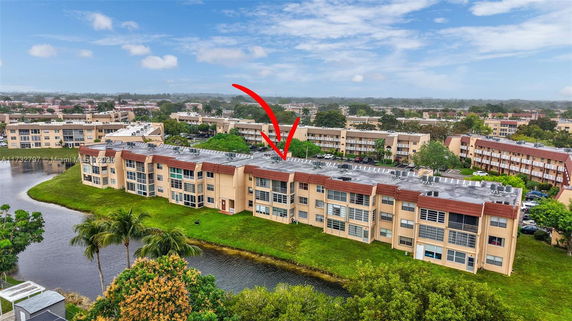 Aerial view of multiple apartment buildings near a water body.
