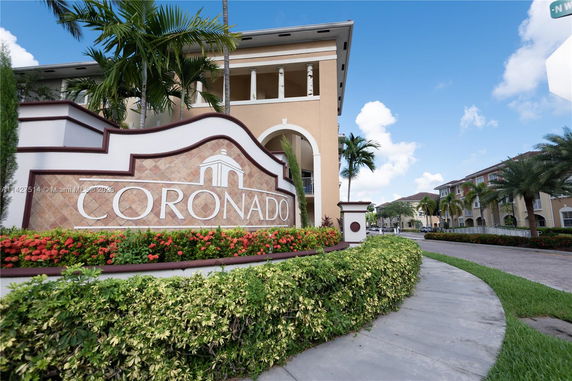 Front view of a multi-story building complex with a prominent sign reading 'Coronado'.