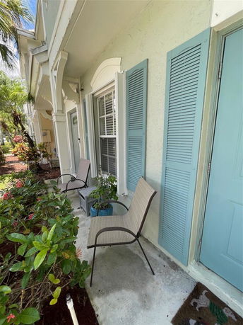 Front view of a house with light blue shutters and a small porch area.