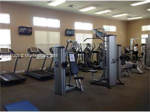 Indoor gym area with exercise equipment and treadmills.