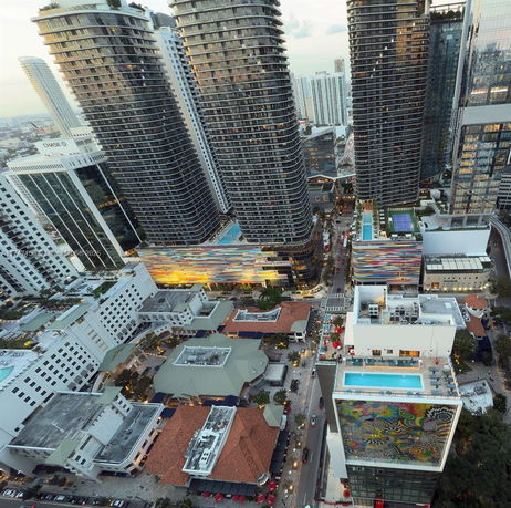 Aerial view of a cityscape with tall skyscrapers and colorful buildings.
