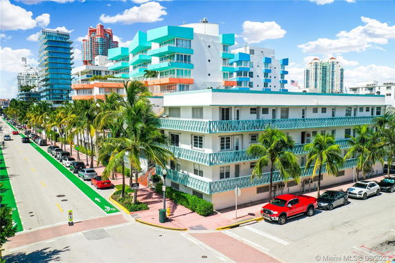 Front view of a multi-story building with a colorful facade and balconies.