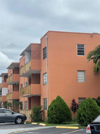 Front view of an apartment building with multiple balconies.