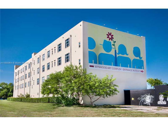 Side view of a multi-story building with artwork on the facade, labeled as Wynwood Art Complex.