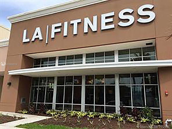 Front view of a fitness center with large windows and signage.