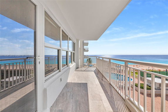Balcony view overlooking the ocean and beach.