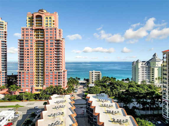 View of a coastal area with tall buildings and the ocean in the background.