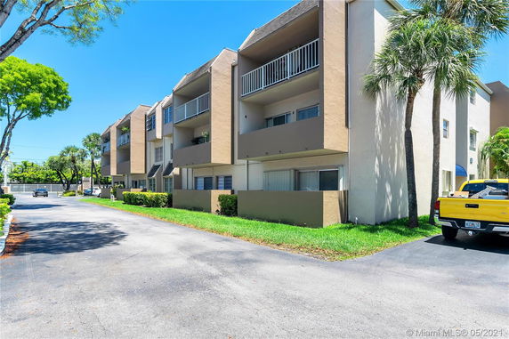 Front view of a multi-story apartment building with balconies.