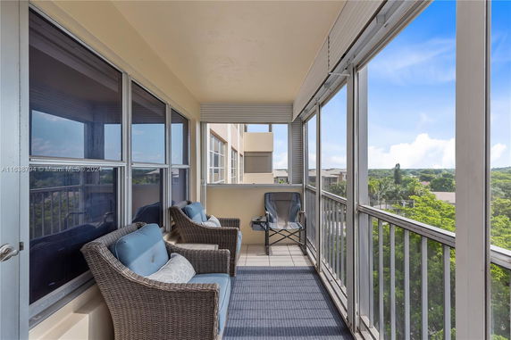 Exterior balcony view with patio furniture and surrounding area visible.