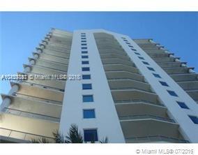 Front view of a multi-story apartment building with multiple balconies.