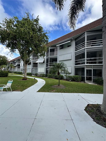 Front view of a multi-story residential building with balconies.