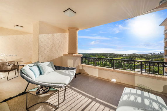 Balcony area with seating overlooking a scenic landscape.