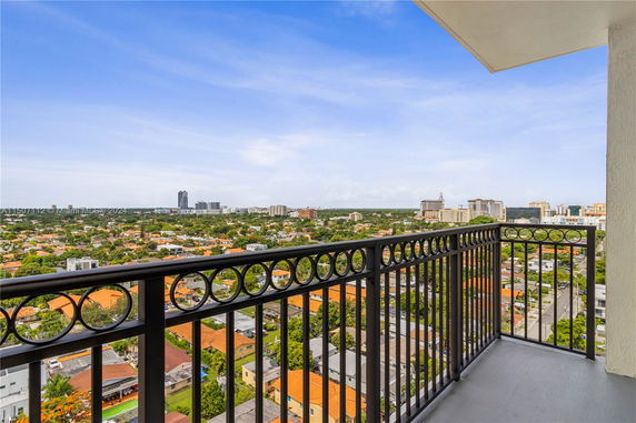 Panoramic view of cityscape from a high-rise balcony.