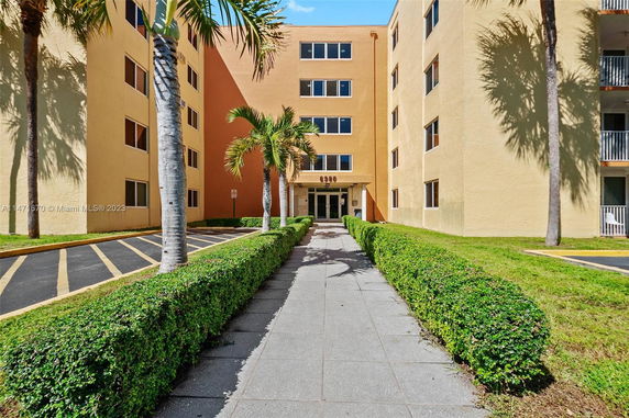 Front view of a multi-story apartment building with a central entrance.