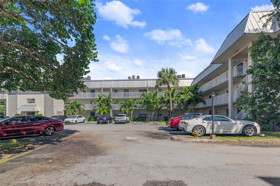 Outdoor parking area in front of a multi-story building.
